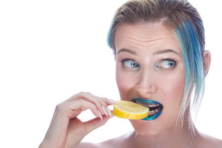 Young Female with Smooth Skin Wearing Teeth Brackets Desperately Biting Slice of Juicy Green Slice...