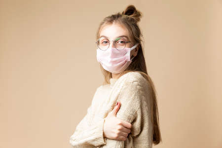Summer Portrait of Resting Relaxing Caucasian Blond Female Girl in Street Clothing Posing On Stones While Sitted On Shoreline Outdoors At Sunny Day. Vertical Imageの写真素材