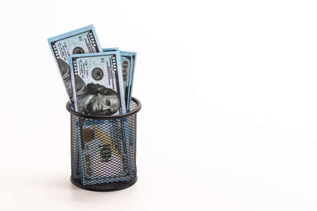 Finances and Savings Concepts. Stack of Money Banknotes in US Dollar Currency Placed in in Basket Against White Background.Horizontal imageの写真素材