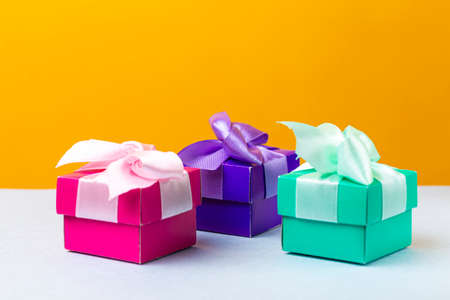 Wrapped Christmas and New Year Gifts of Various Colors Placed in Line on Yellow Blue  Background. Horizontal Imageの写真素材
