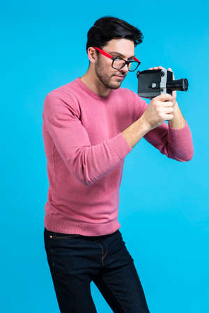 Funny and Smiling Caucasian Handsome Guy Standing With Artistic Paper Glasses in Casual Clothing...