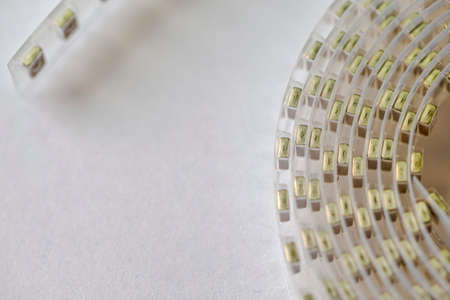 Microelectronic Ideas. Closeup of Tape with SMD or Surface Mount Inductance Components in Tape Together On White. Horizontal Orientationの写真素材