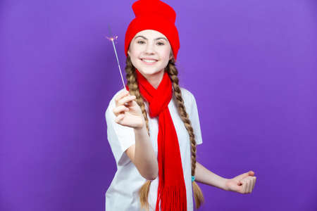 One Expressive Caucasian Girl in Red Warm Hat and Red Scarf Having Fun With Vivid Bright Burning...