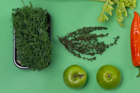 Upper Closeup Flat-Lay View of Variety of Fresh Fruits and Vegetables Placed on Trendy Green...