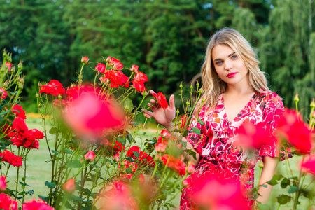 Close up Romantic Portrait of Beautiful Elegant Caucasian Winsome Female Woman in Summer Blossoming Trees. Vertical Imageの写真素材