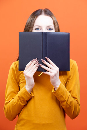 Girl in Yellow Shirt Posing isolated on Orange Background Studio Portrait as People Lifestyle...