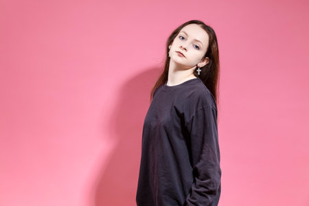 Portrait of Winsome Attractive Slim Young Girl in Big Trousers Showing Successful Weight Loss...