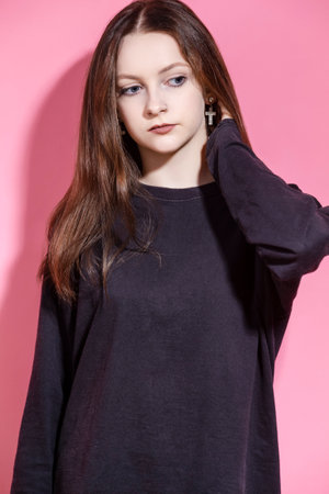 Hairloss Issues. Young Caucasian Female Having Hair Problems as Checking Hair in Hairbrush While Posing in Red Dress Against Pink.Vertical Shotの写真素材