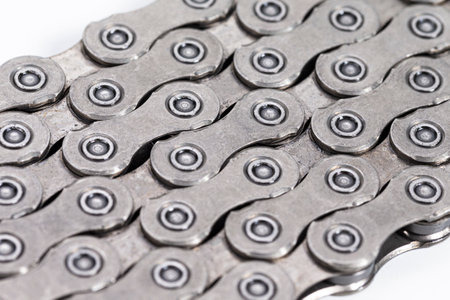 Extreme Closeup Background Texture of New Good Oiled Roller Bicycle Chain from Top View. Horizontal...