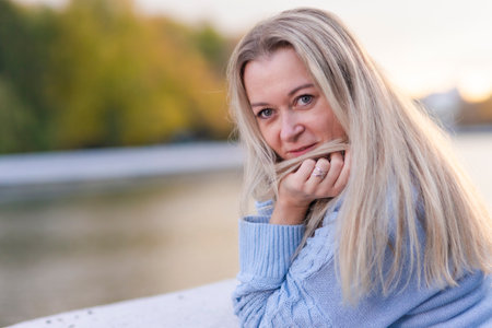People Ideas. Winsome Caucasian Beautiful Young Woman Walking in Autumn Park Outdoors. Horizontal Shotの写真素材