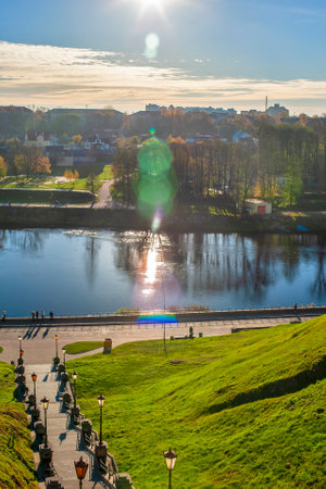 Cityscape of Old city Grodno In Autumn Morning With Old Houses and River Embankment In background On Cloudy Sky. Vertical Imageの写真素材