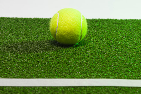 Sport Ideas. Variety of Tennis balls on green artificial grass surface. Horizontal Imageの写真素材