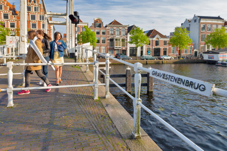 Harlem, The Netherlands -  May 6, 2017: People Walking on Gravestenenbrug Bridge on Spaarne River in Harlem City in The Netherlands, May 6, 2017のeditorial素材