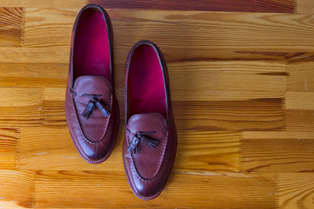 Wonderful Traditional Formal Stylish Brown Pebble Grain Tassel Loafer Shoes Inline Placed On Wooden Surface. Horizontal Shotの写真素材