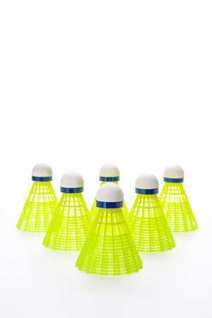 Upper Top View of Shuttlecocks Set Arranged on White Background As Flatlay with Copy Space. Vertical...