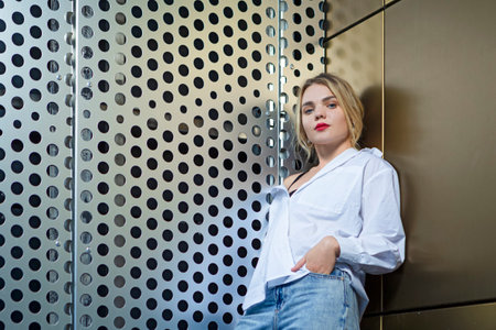 Fashion Portrait of Winsome Pretty Smiling Girl Woman in White Shirt Standing in Front of Dotted...