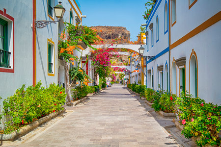 Pedestrian Street in Puerto de Mogan At Gran Canaria in Spain as Favorite Tourist and Vacation Place on The Island with Lots of Bougainvillea Flowers.Horizontal Imageの写真素材