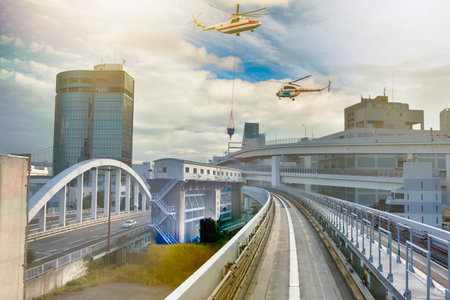 Cityscape View Taken From Monorail Odaiba Sky Train in Tokyo With Two Helicopters Hovering Over the City. Horizontal imageの写真素材