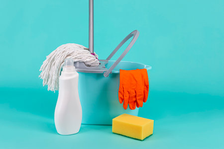 Line of  Accessories as a Set of Bucket, Mop and Cleaning Supplies On Turquoise Background Indoors.Horizontal Shotの写真素材
