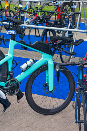 Line of Professional Carbon Road Bikes With Deep Profile Carbon Aero Wheelset Placed Together During Triathlon Cycling Competition. Vertical Image Compositionの写真素材