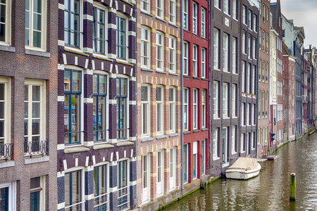 Picturesque City of Amsterdam. One of The Canals of Amsterdam At Daytime. Horizontal Image Orientationの写真素材