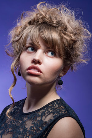 Caucasian Blond Woman with Curly Stylish Hair Against Colorful Light Violet Background.Vertical...