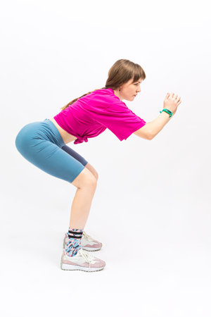 Sportive Caucasian Female During Legs and Torso Musles Body Stretching Exercises While Sitting...