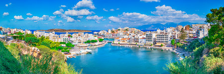 Travel Concepts. Picturesque View of Colorful Agios Nikolaos Village with Prodigious Voulismeni Lake Taken from View Point as Famous Travel Tourist Destination of Crete Island in Gの写真素材
