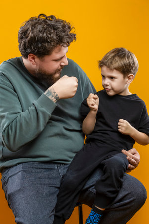 Portrait of Young Funny Smiling Cheerful Playing Parent Dad with Boy Child In Casual Clothing With...