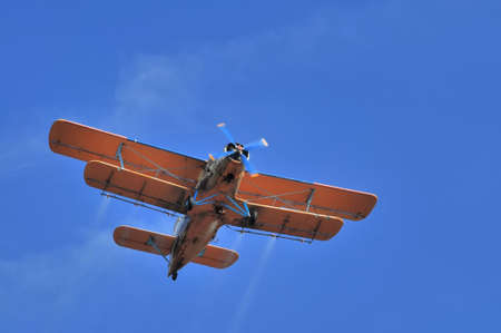 Duster airplane on clear blue sky