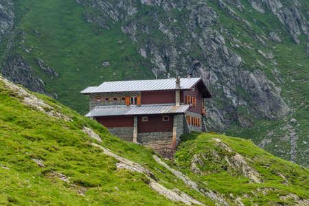 Stone and wood chalet on the mountain range