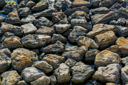 Stones and water background. Seashore with rocks in water on Black Sea.の写真素材