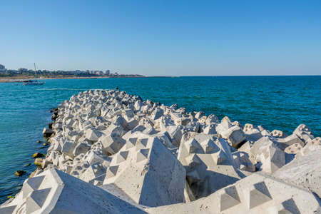Tetra-pods or concrete breakwater blocks at Tomis, Constanta harbor. Sea wall for protect the beach....