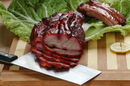 Cantonese cuisine Char siu  literally "fork-roast" on a cutting boardの写真素材