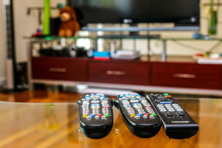 t v remote control at a glass tableの写真素材