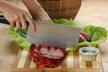 Cantonese cuisine Char siu  literally "fork-roast" on a cutting boardの写真素材