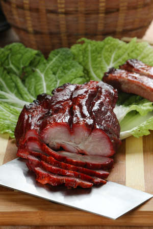 Cantonese cuisine Char siu  literally "fork-roast" on a cutting boardの写真素材