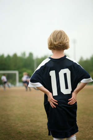 Blonde girl playing soccer / footballの写真素材