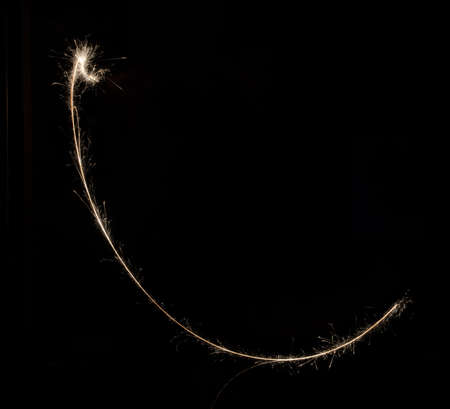 sparkler light trail in dark environment using slow shutter speedの写真素材