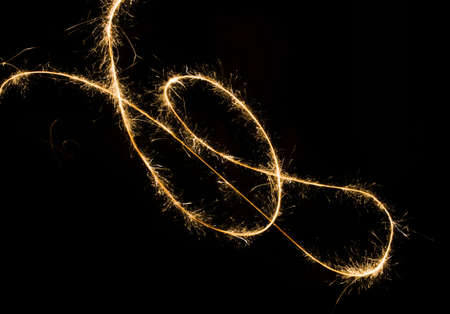 sparkler light trail in dark environment using slow shutter speedの写真素材