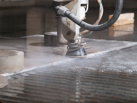 water pressure cutting through stainless steel materialsの写真素材