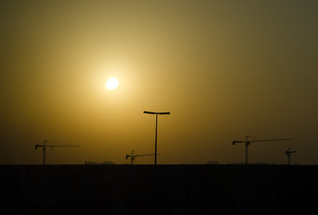 dubai dust storm with construction cranes silhouetteのeditorial素材