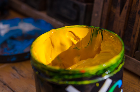 yellow acrylic paint pot preparing for mono print and screen printingの写真素材