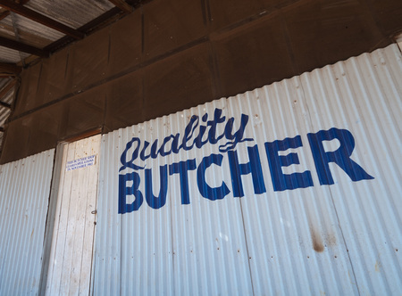 Western Australia, Australia, 08/08/2015, Old abandoned hand painted butchers shop sign in a small outback townのeditorial素材