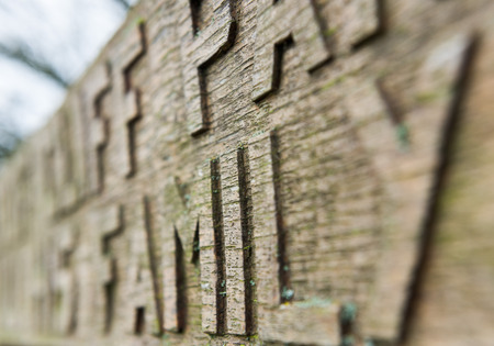 Hand carved chiseled letters on an old wooden bench covered in mossの写真素材