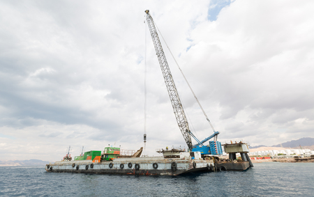 Aqaba, Jordan, 10/10/2015, Construction crane working on a jetty terminal at aqaba new port.のeditorial素材