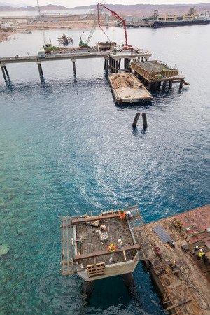 Aqaba, Jordan, 10/10/2015, Metal and concrete Jetty foundation construction at the Aqaba new port photographed from aboveのeditorial素材