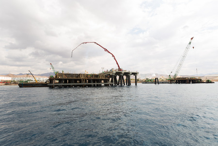 Aqaba, Jordan, 10/10/2015, Construction crane working on a jetty terminal at aqaba new port.のeditorial素材