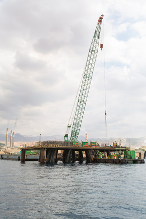 Aqaba, Jordan, 10/10/2015, Construction crane working on a jetty terminal at aqaba new port.のeditorial素材