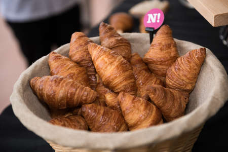 Fresh, warm organic french croissant collection in a rustic basketの写真素材